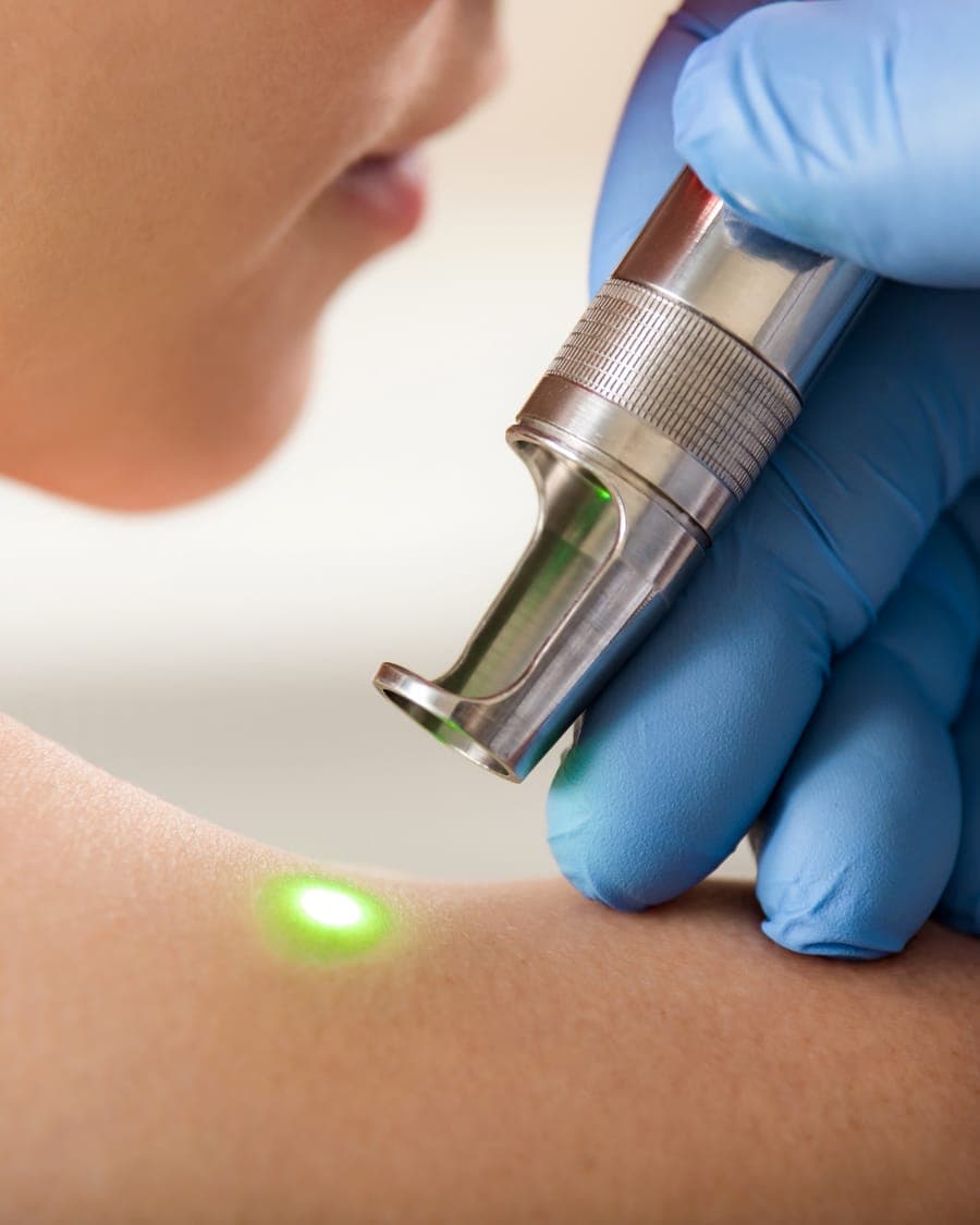 Treatment device held against the skin of a shoulder